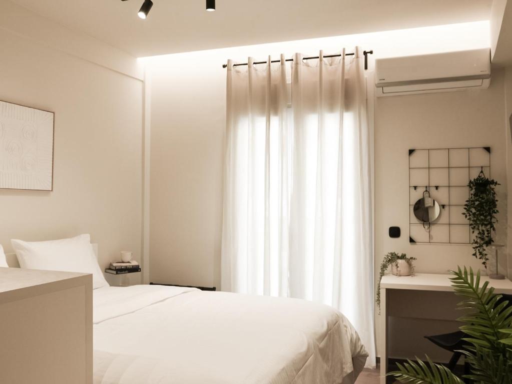 a bedroom with a white bed and a window at Skyline Cube in Thessaloniki