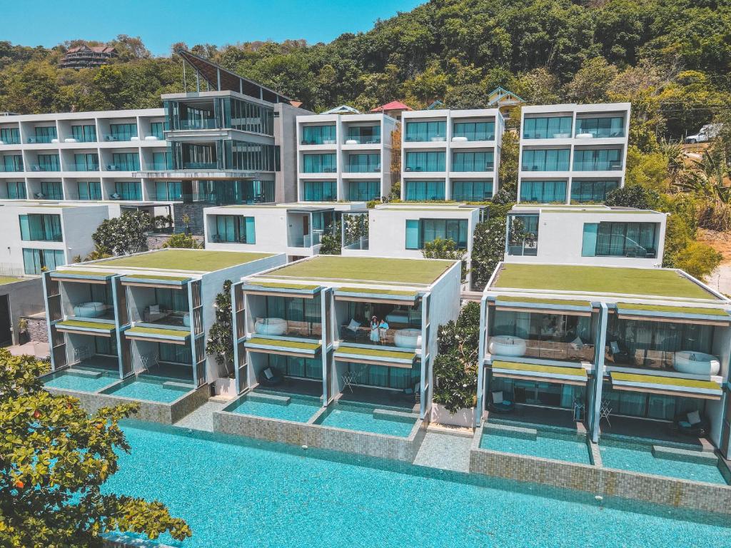 an aerial view of a building with a swimming pool at My Beach Resort Phuket, Panwa Beach in Panwa Beach
