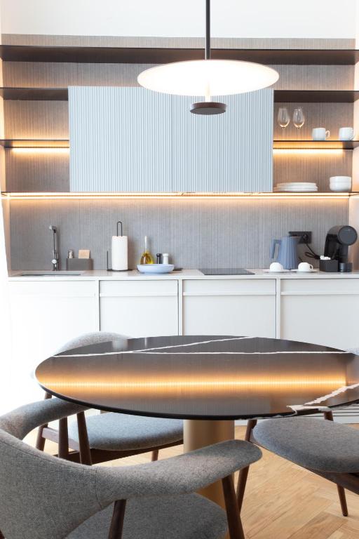 A kitchenette and dining table with integrated lighting and small appliances.
