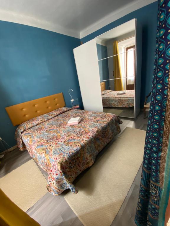 a bedroom with a bed and a mirror at Pinerolo medievale in Pinerolo