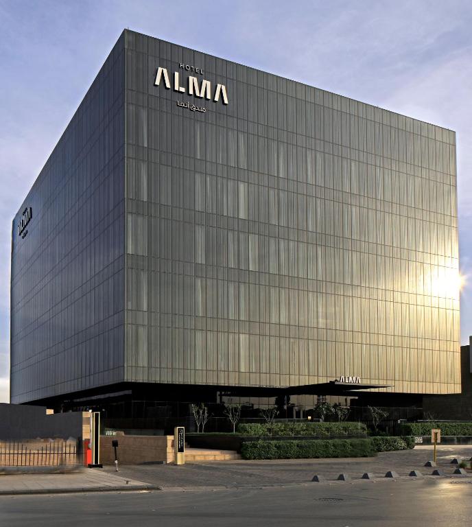 a building with a sign on the side of it at ALMA Hotel Riyadh in Riyadh