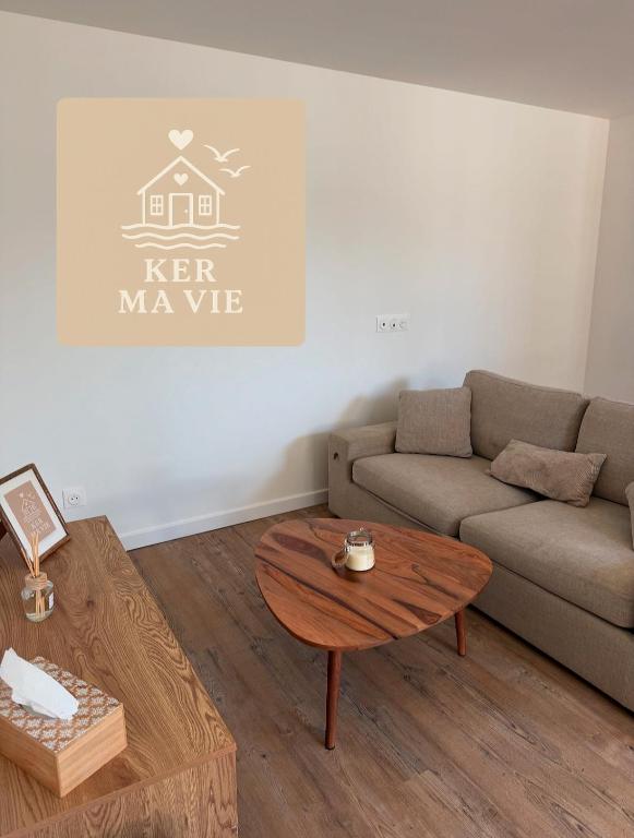 a living room with a couch and a coffee table at Petite maison à 1km de la plage in Batz-sur-Mer