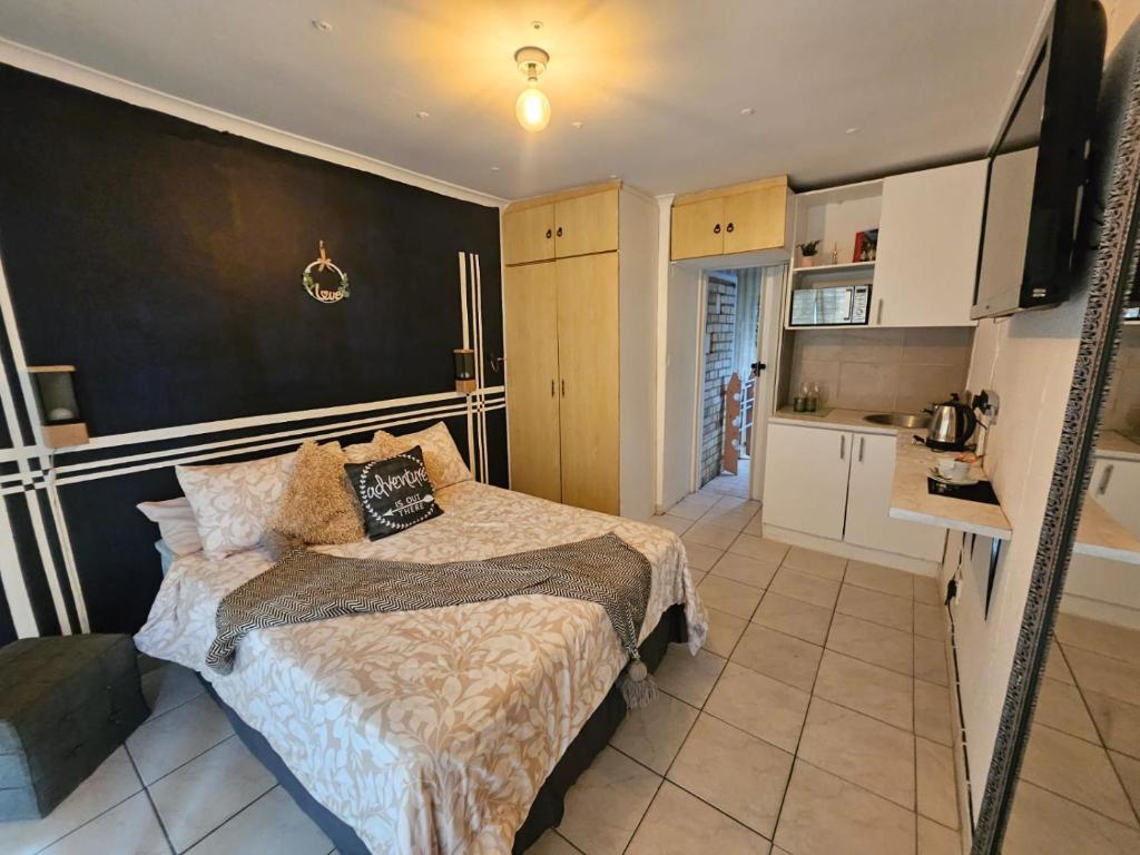 a small bedroom with a bed and a kitchen at 12 on lake in Parkwood