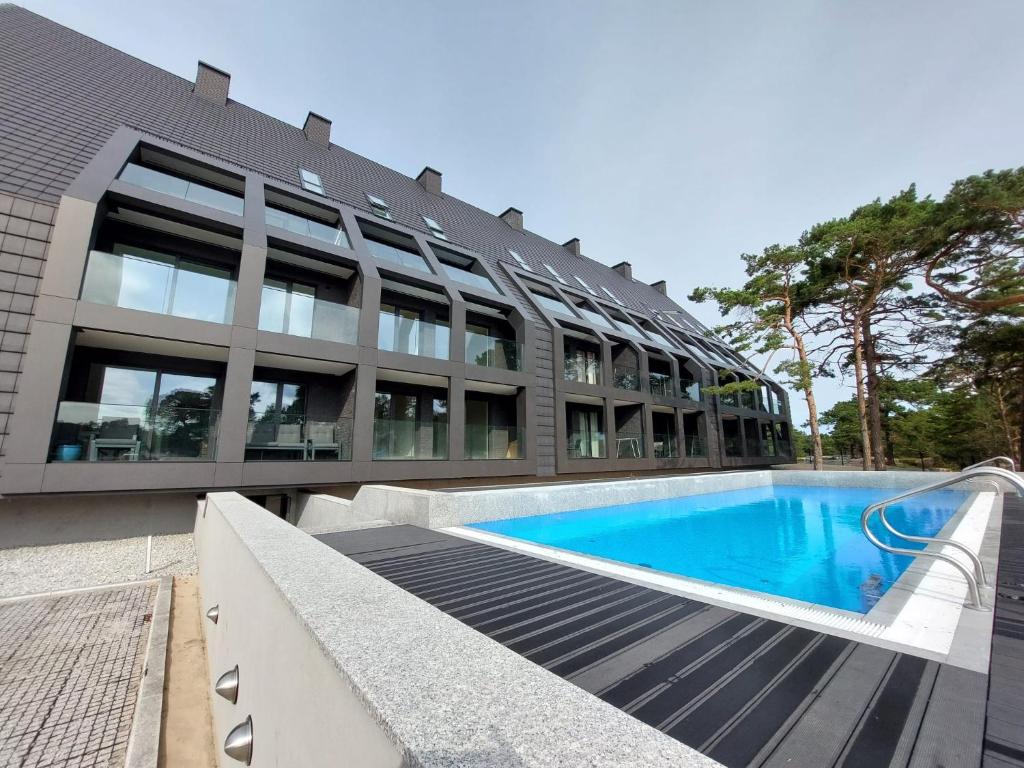 an external view of a building with a swimming pool at Czarna Perła in Hel