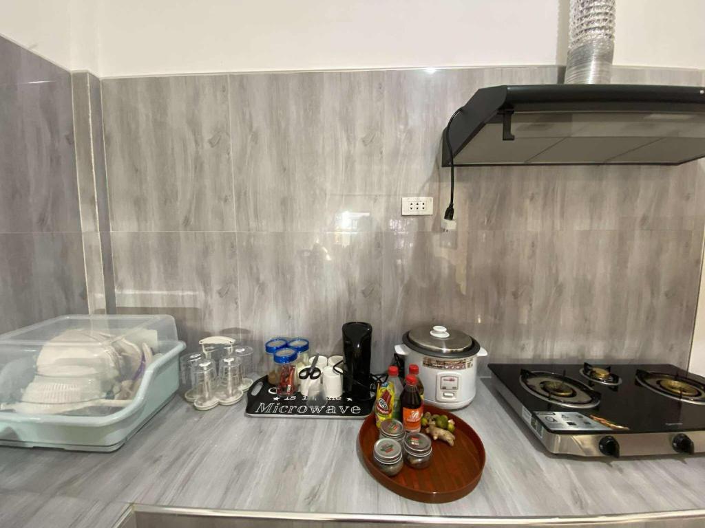 a kitchen with a counter with a stove and a counter top at Cozy Home in Malaybalay 2 Bedrooms and 1 Bathroom in Malaybalay