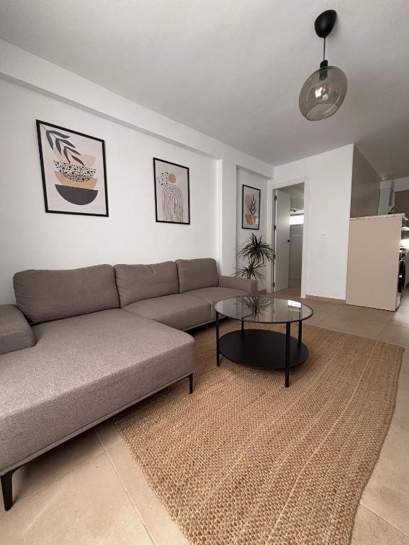 a living room with a couch and a table at Apartamentos RoMar Campillos in Campillos