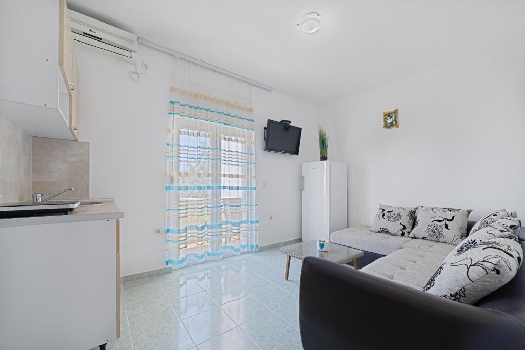 a living room with a couch and a table at Apartment Dragicevic 3 with Garage in Budva