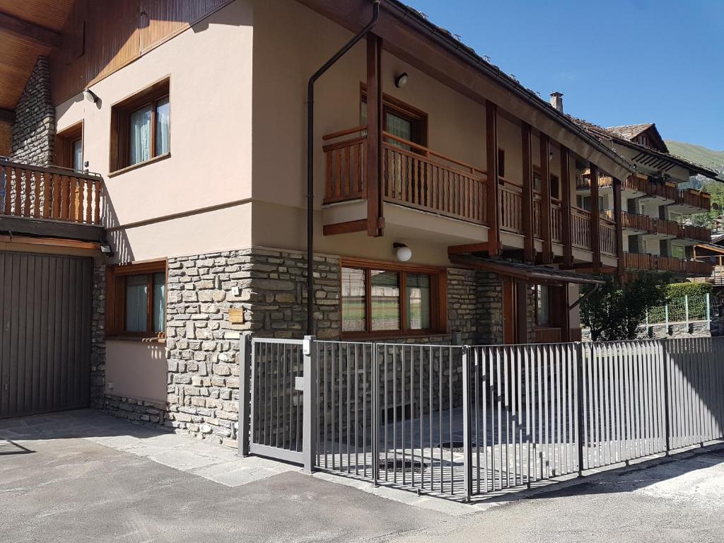 a house with a fence in front of it at Villa Monti in Courmayeur