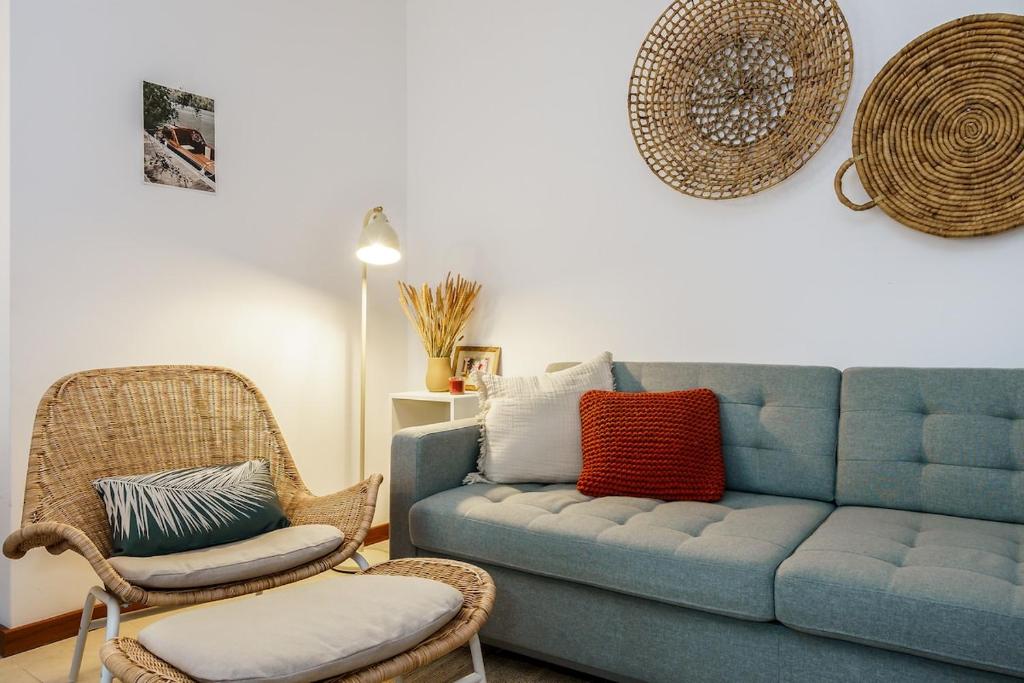 a living room with a blue couch and two chairs at 1 Bedroom apt with pool access in Albufeira
