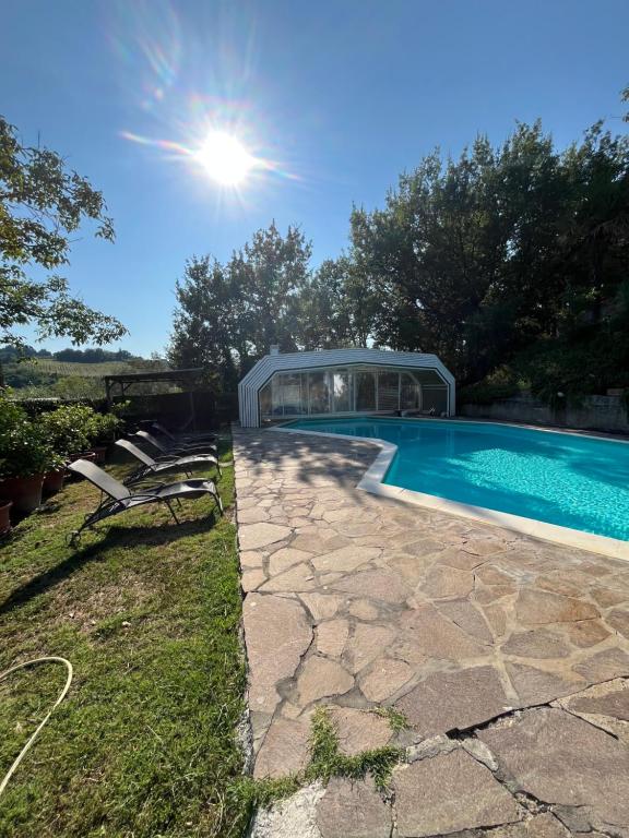 a swimming pool with a glass house in a yard at Villa Caterina 1 by falcony apartments in Montespertoli