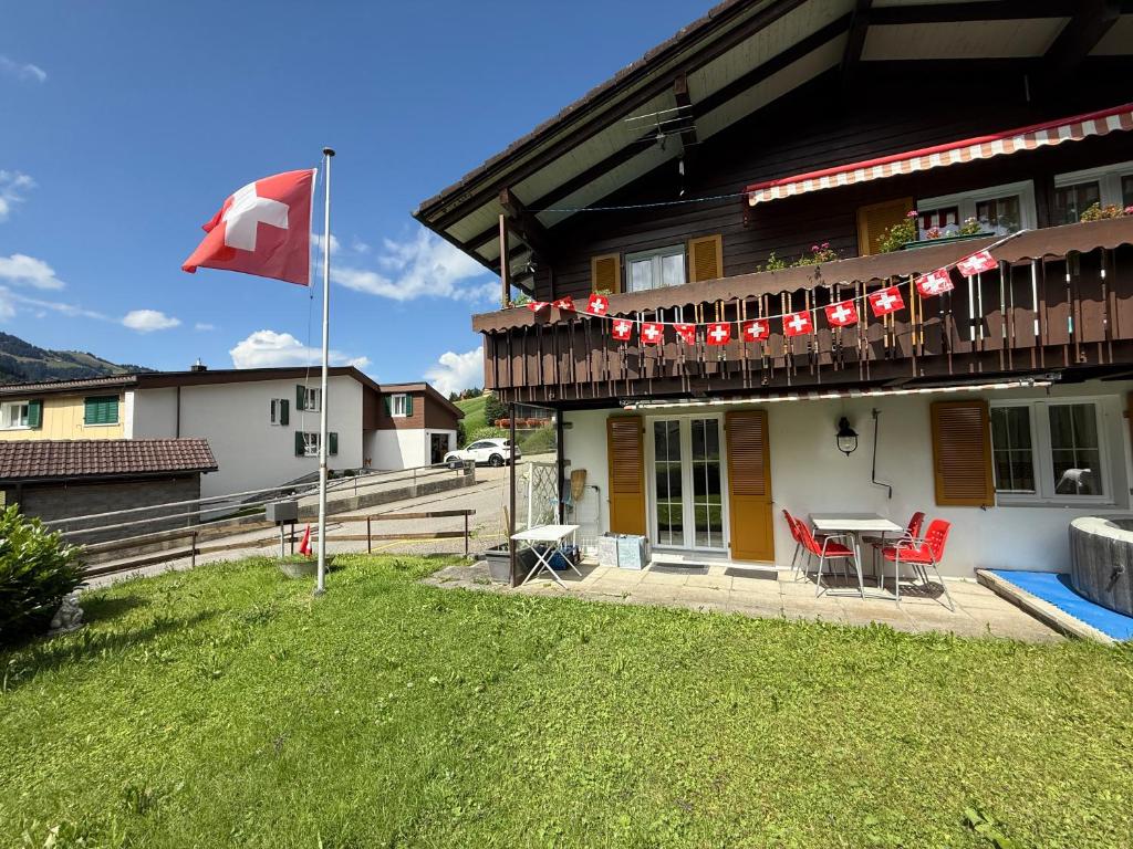 a canadian flag flying in front of a house at Free Spirit Chalet in Flühli