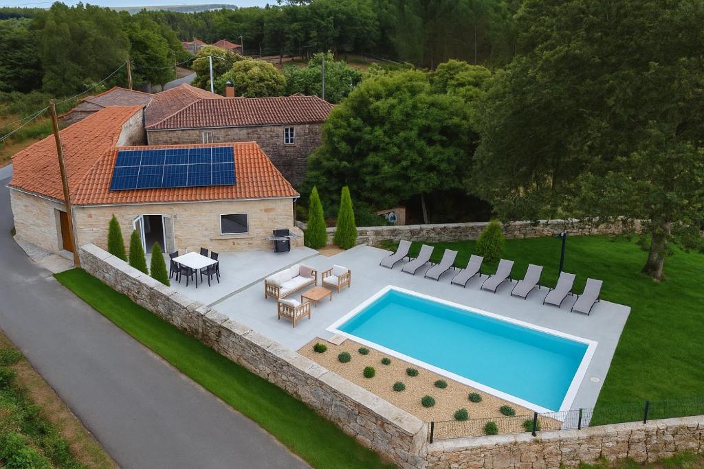 an aerial view of a house with a swimming pool at Reverence Villas Avieira in Carballal