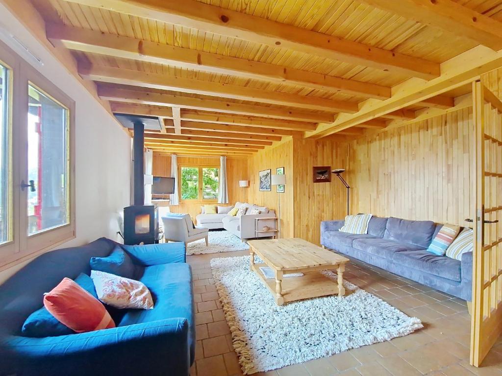 a living room with a blue couch and a table at CHALET AVORAZ AVR NATURE & VIEW 10 Pers in Châtel