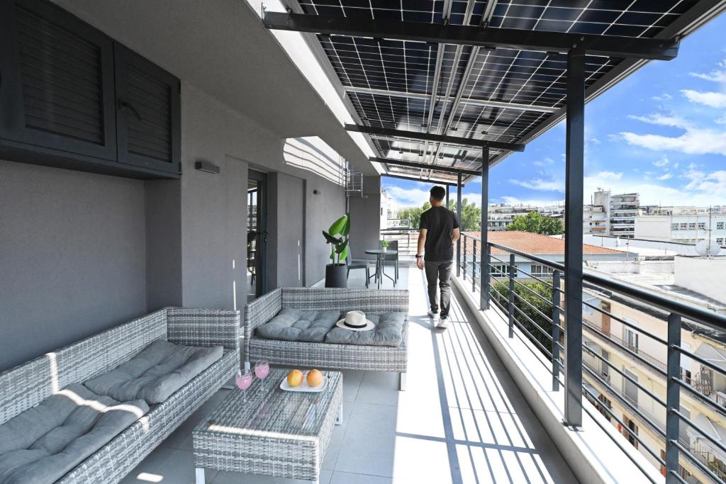 a man walking on the balcony of a building at ICON Urban Living in Thessaloniki