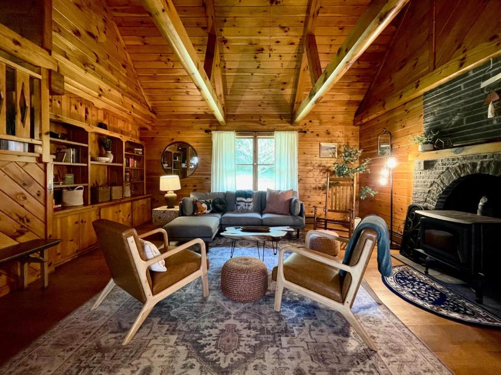 a living room with a couch and a fireplace at Fire Pit, Bbq & Sprawling Lawn Elk Point Cabin in Livingston Manor