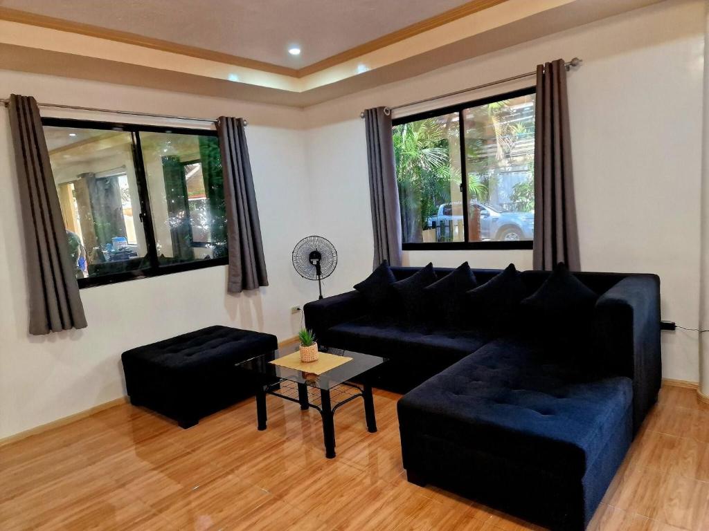 a living room with a couch and a table at 3 Bedrooms 2 storey House in Dipolog