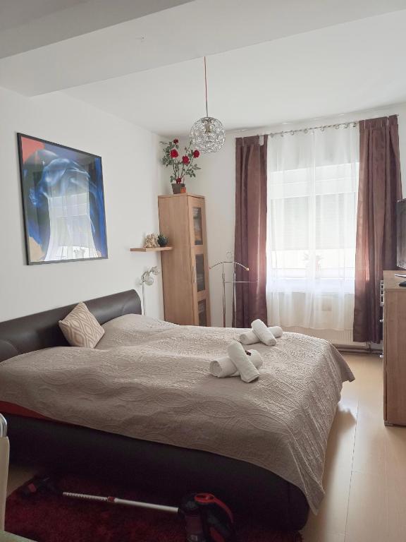 a bedroom with a bed with two towels on it at Charly's Home in Villach