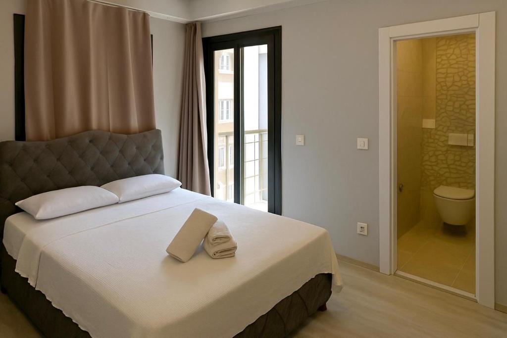 a bedroom with a bed with two towels on it at Kadıköy Miski Amber in Istanbul
