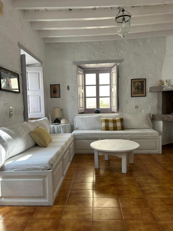 a living room with a couch and a table at Villa Iza in Skala