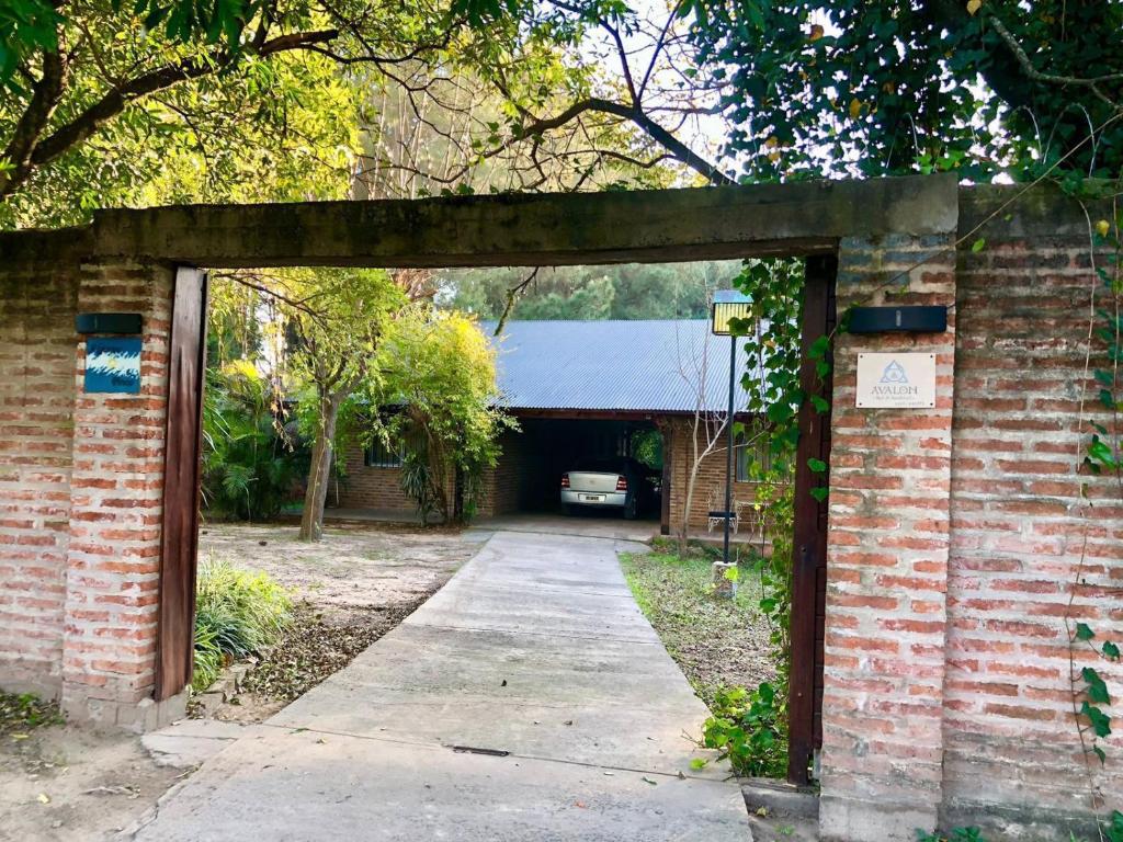 an entrance to a brick building with a driveway at Avalon in Esquina