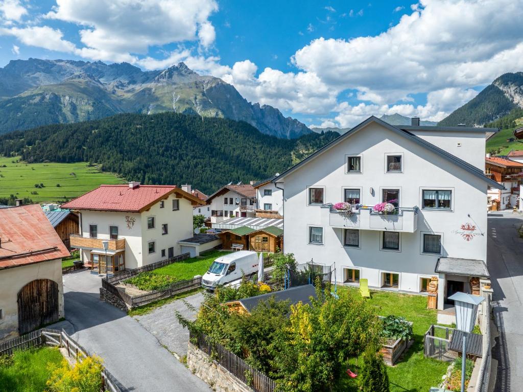 a village in the mountains with a white house at Apart Moriggl in Nauders