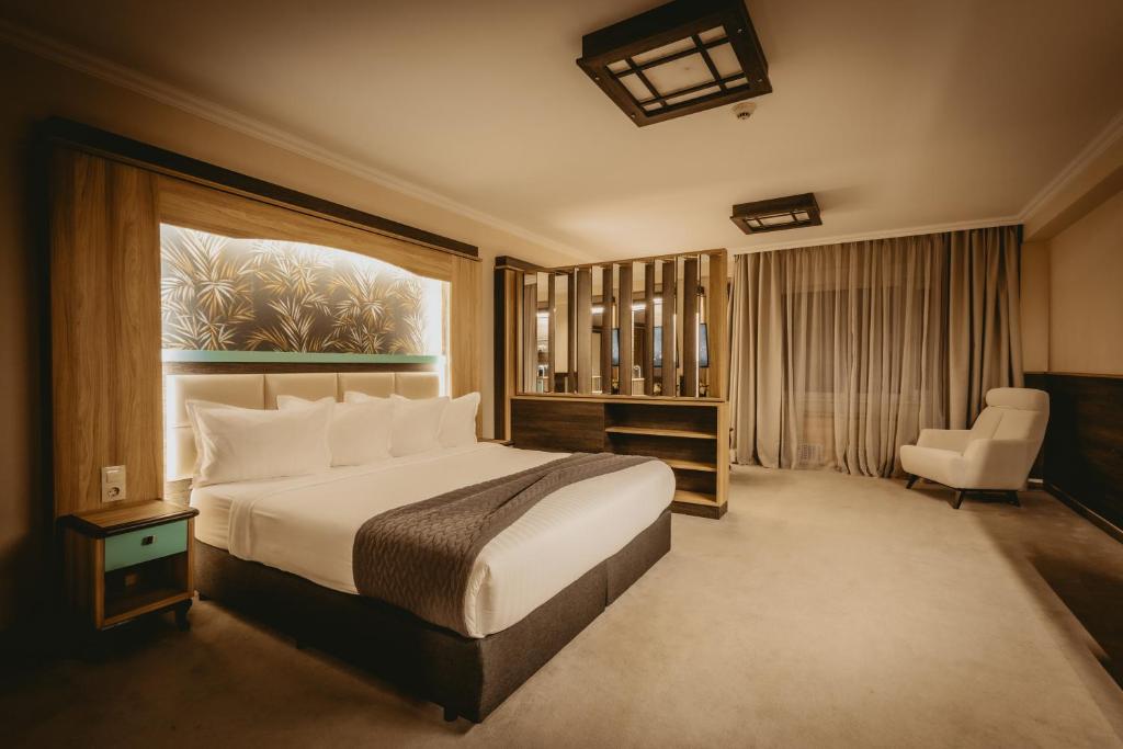 a hotel room with a bed and a chair at Hotel ZOO Sofia in Sofia