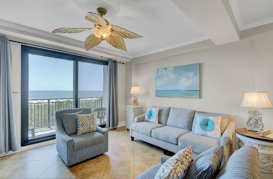 a living room with a couch and a ceiling fan at Shipwatch 405A by Wild Dunes, Oceanfront Condo in Isle of Palms