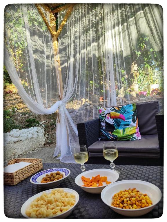 a table with plates of food and glasses of wine at Casa Maibeca in Bolbaite