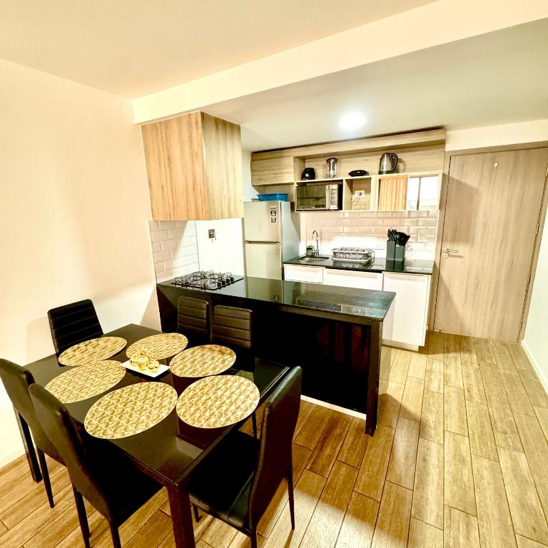 eine Küche und ein Esszimmer mit Tisch und Stühlen in der Unterkunft Depto amoblado 2 dormitorios Equipetrol in El Pary