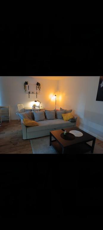 a living room with a couch and a table at Słoneczny Zakątek b in Złotów