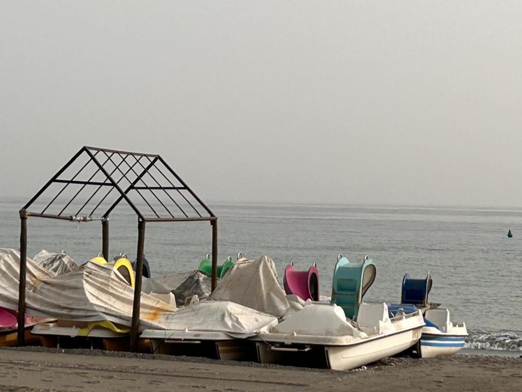 a group of boats sitting on the beach at Piso Torrox Costa Málaga in Torrox