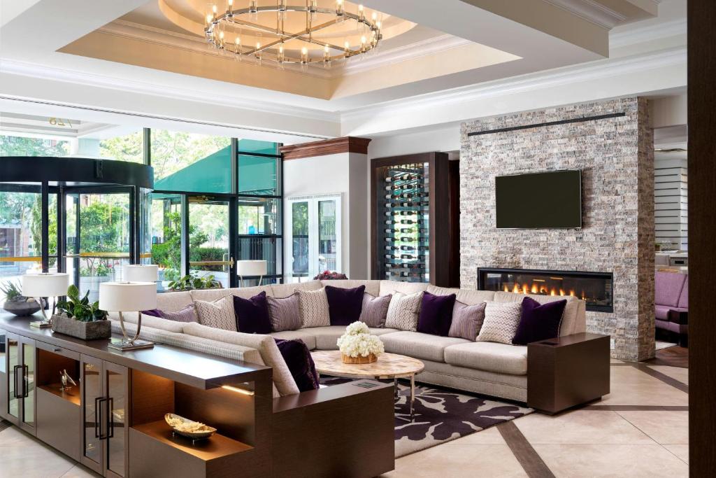 a living room with a couch and a fireplace at Victoria Marriott Inner Harbour in Victoria