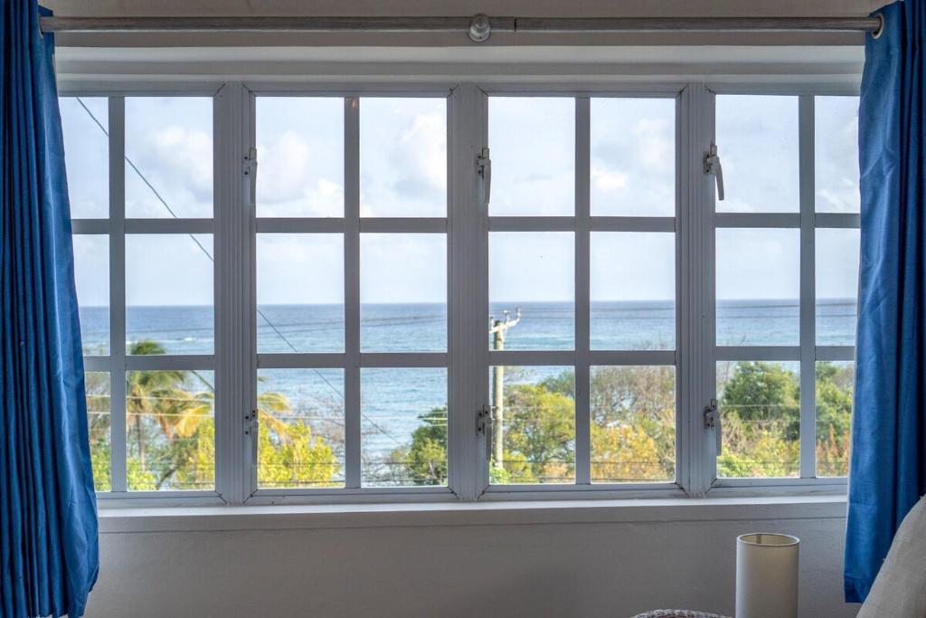 a window with a view of the ocean at Flip-Flops at Sapphire House in Laborie