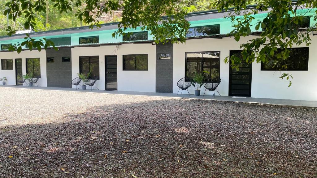 a building with chairs in front of it at Villas Anna Bertha 2 noches minimo in San Isidro