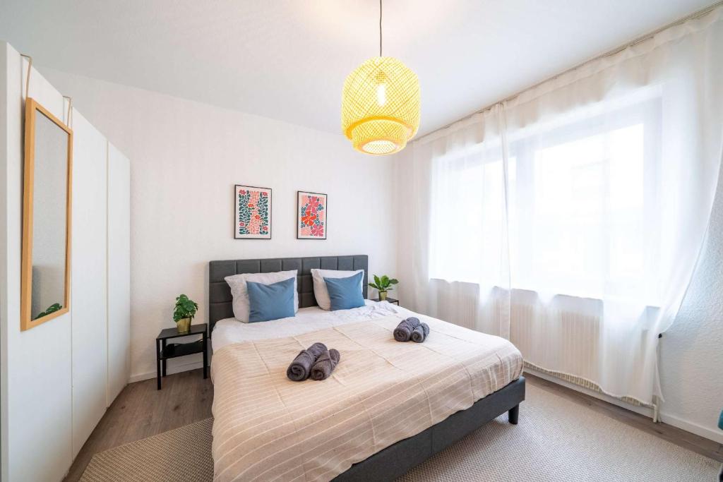 a bedroom with a large bed with two bags on it at 6P Zentrale Suite mit Balkon & Parkplatz in Witten