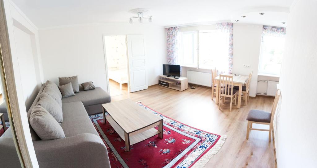 a living room with a couch and a table at Lastekodu Apartment in Tallinn