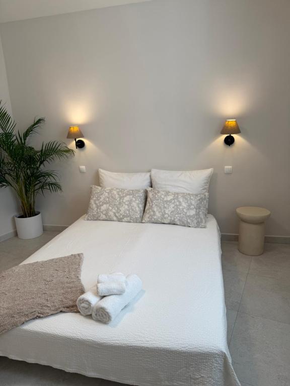 a bedroom with a white bed with towels on it at Apartment Korčula in Korčula