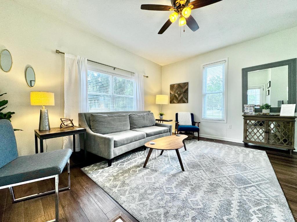 a living room with a couch and a ceiling fan at Loft On Landess in Marion