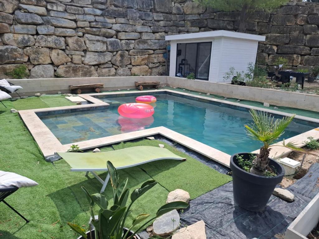 a swimming pool with a frisbee in it at Bastide la Bohême in La Ciotat