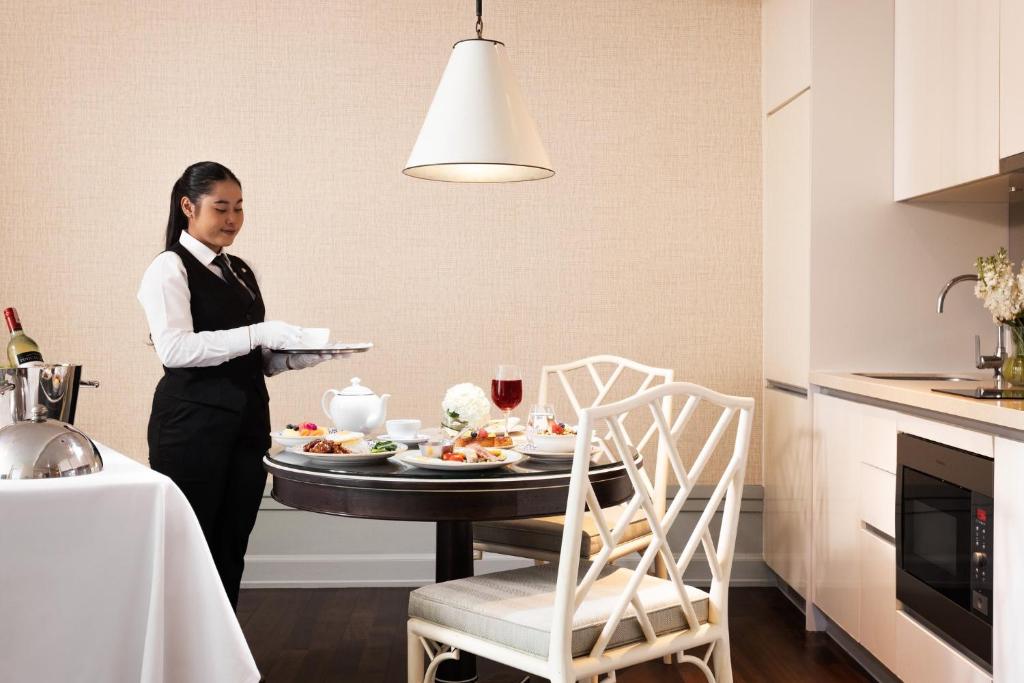 A staged in-suite dining scene beside the fitted kitchen.