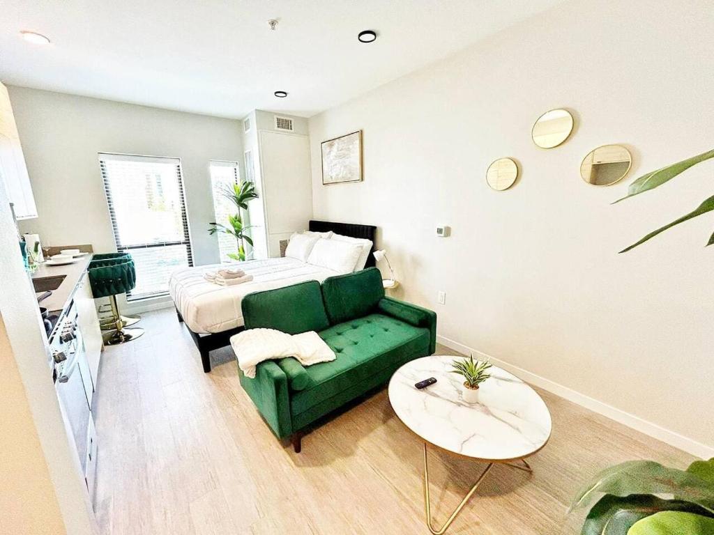 a bedroom with a bed and a green couch at Tranquil Escape in Des Moines