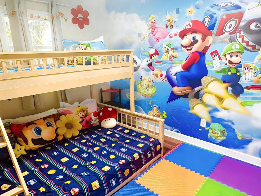 a bedroom with a mario party mural on the wall at Flower Bliss Cottage in Sparta Mountains in Sparta