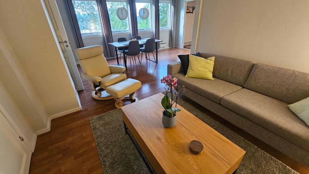 a living room with a couch and a coffee table at Private, Comfortable, 70 sq m in Tromsø
