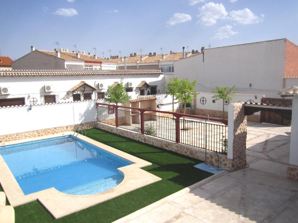 a swimming pool on the roof of a building at Apartamentos Venta Don Quijote in Almagro