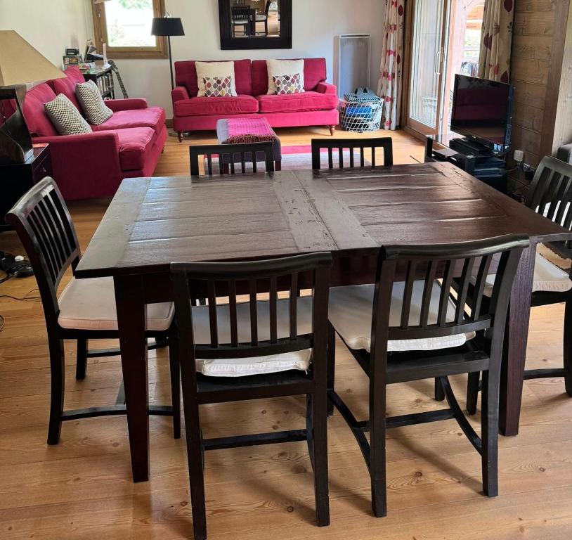 a wooden table and chairs in a living room at Hameaux du glaciers in Les Houches