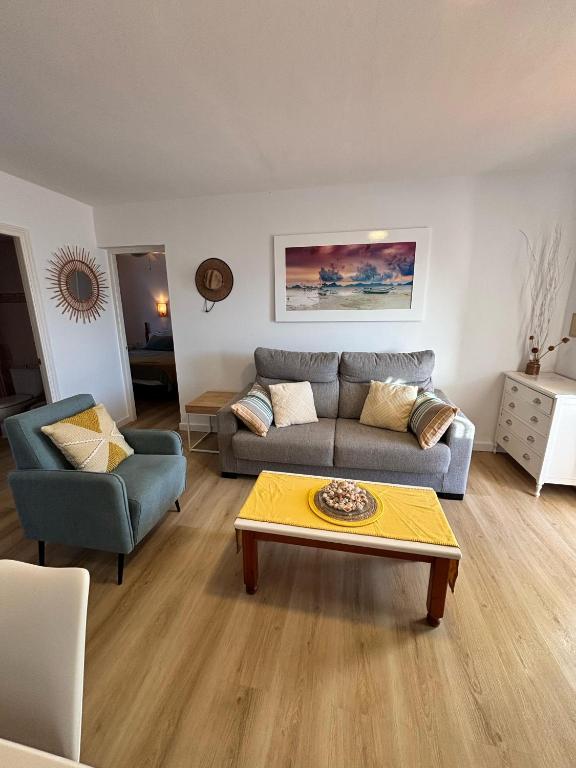 a living room with a couch and a coffee table at Apartamento 313 Castell Sol CB in Arenal d'en Castell