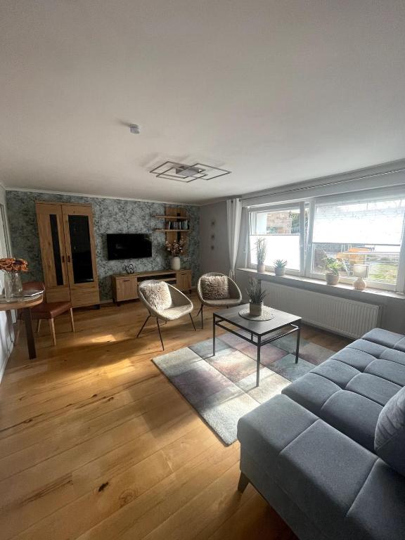 a living room with a couch and a table at Eifeltraum Mendig, 3 Sterne, Ferienwohnung in Mendig