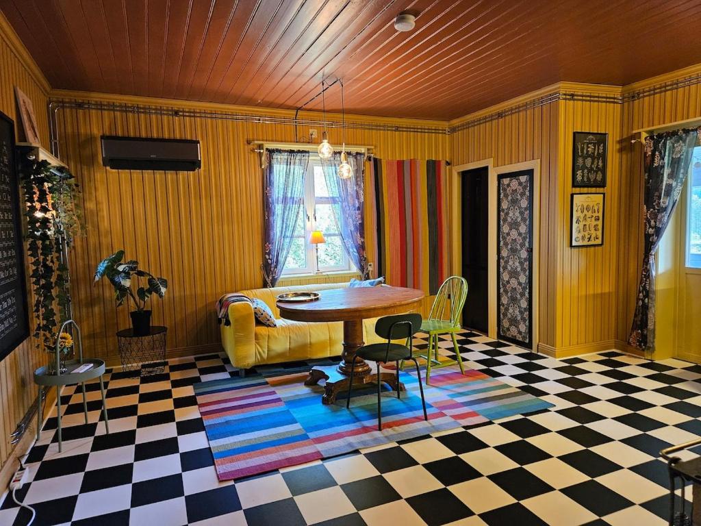 a living room with a table and a checkered floor at Beautiful house in Fränsta in Fränsta