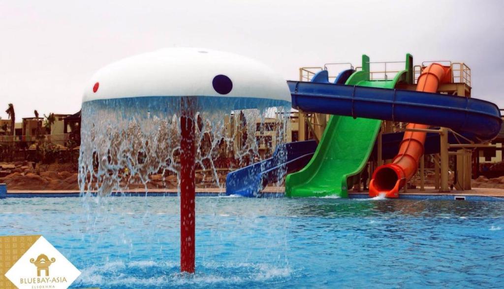 a water park with a water slide in the water at BlueBay-Asia Elsokhna -Families Only in Ain Sokhna