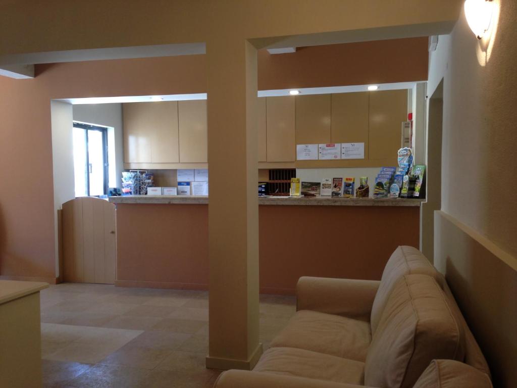 a living room with a couch and a kitchen at Vilamar in Luz